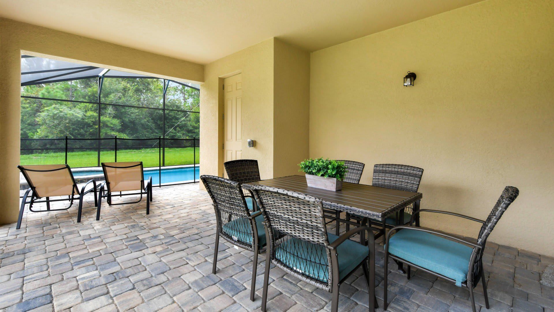 Covered patio with outdoor dining, pool views, and peaceful nature surroundings!