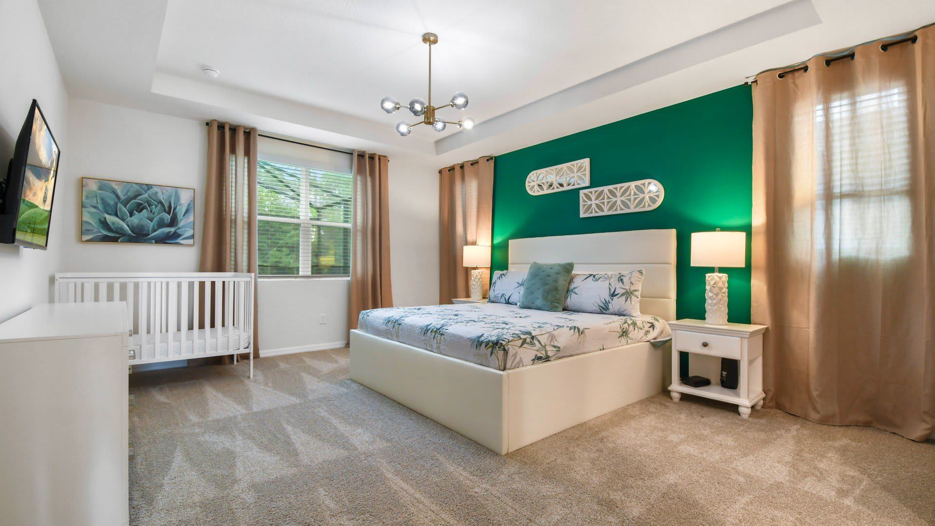 The master bedroom features a luxuriously large king bed with a crib