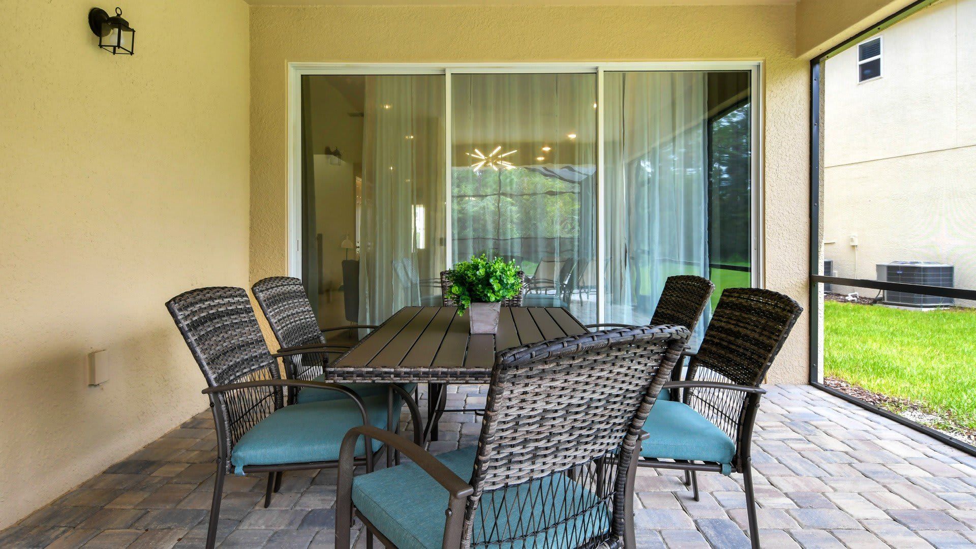 Covered patio with outdoor dining, pool views, and peaceful nature surroundings!