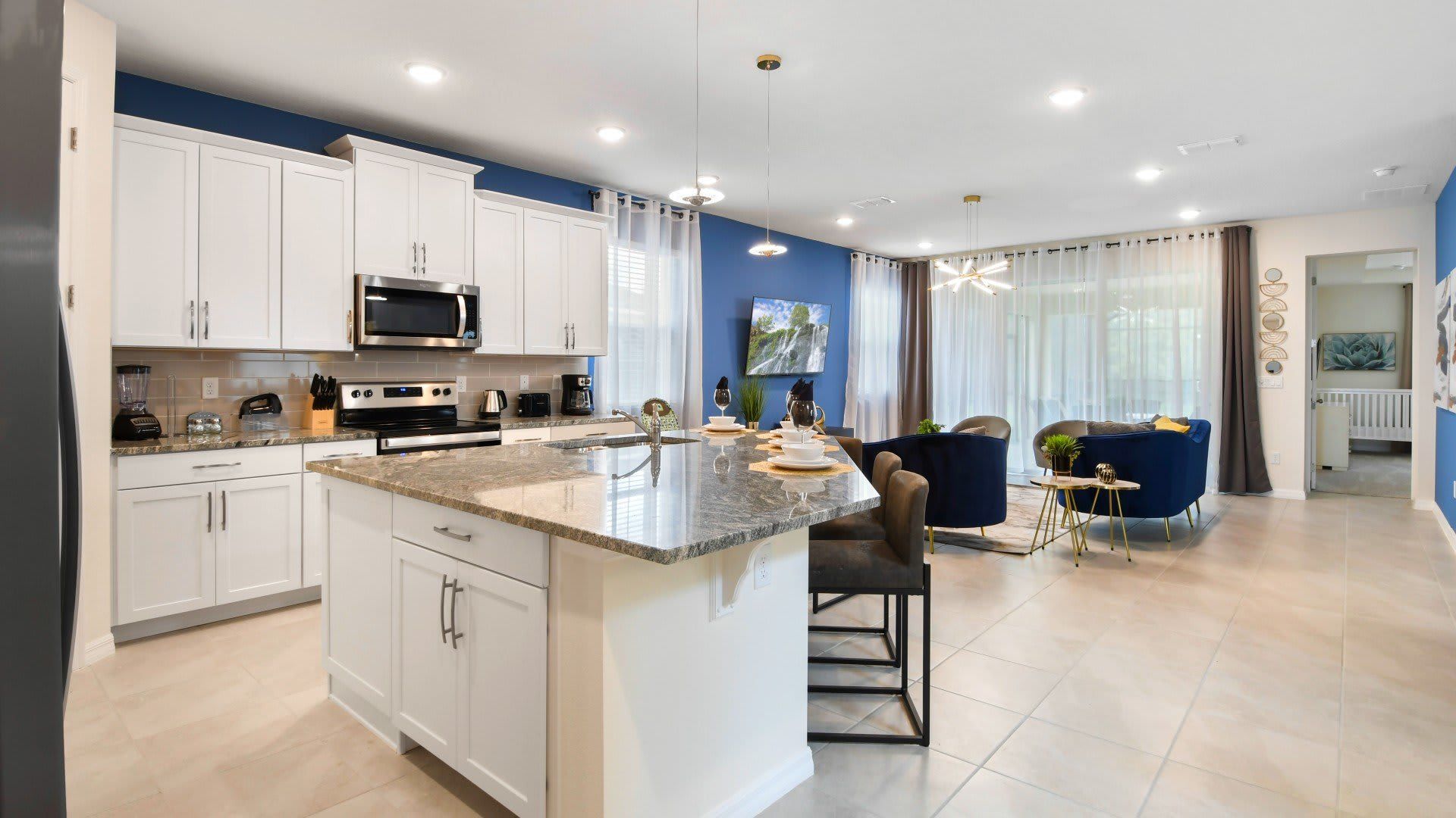 Modern open-concept kitchen with sleek white cabinets, granite countertops, and style!