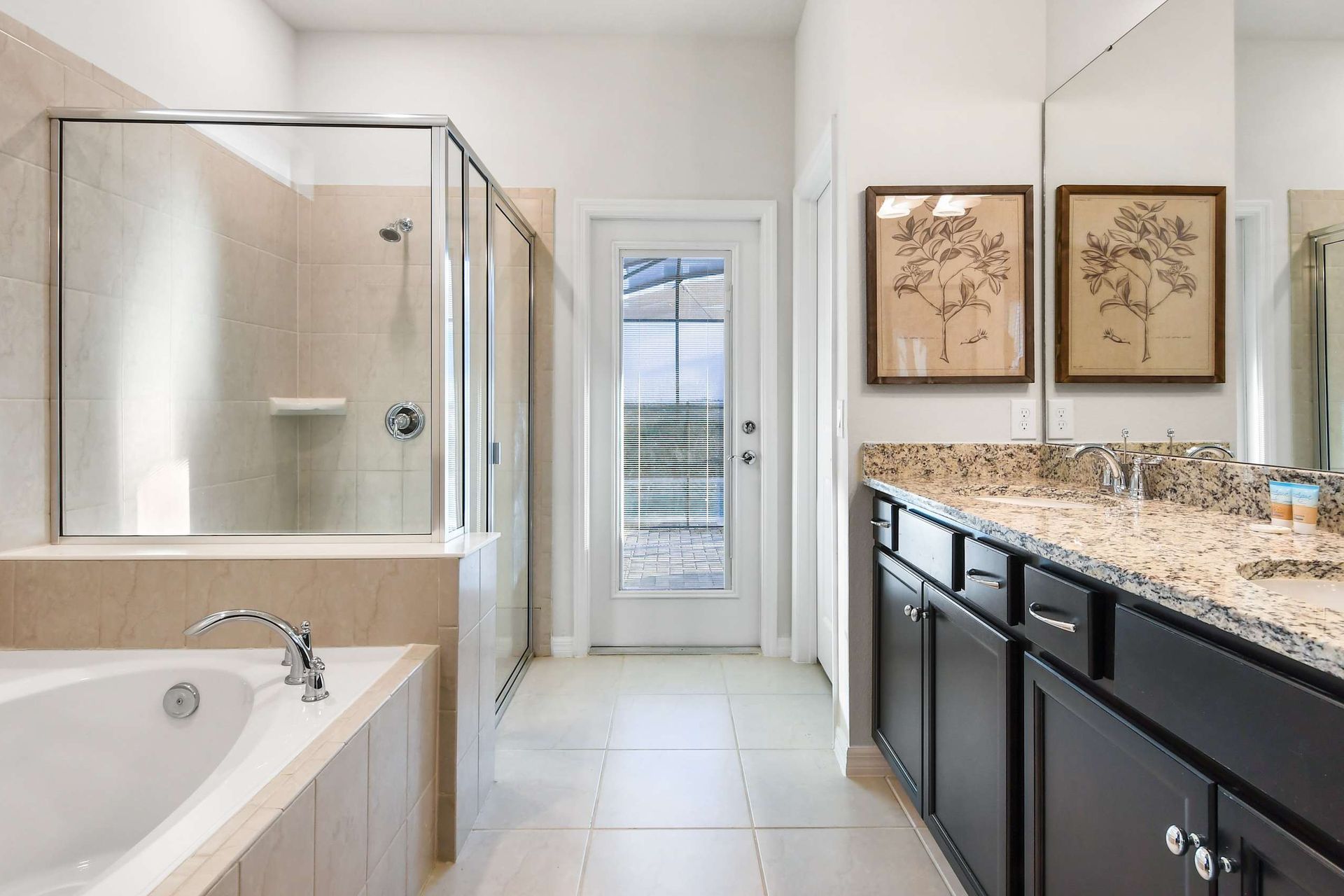 Luxurious master bathroom with dual sinks, granite countertops, walk-in shower, and soaking tub.