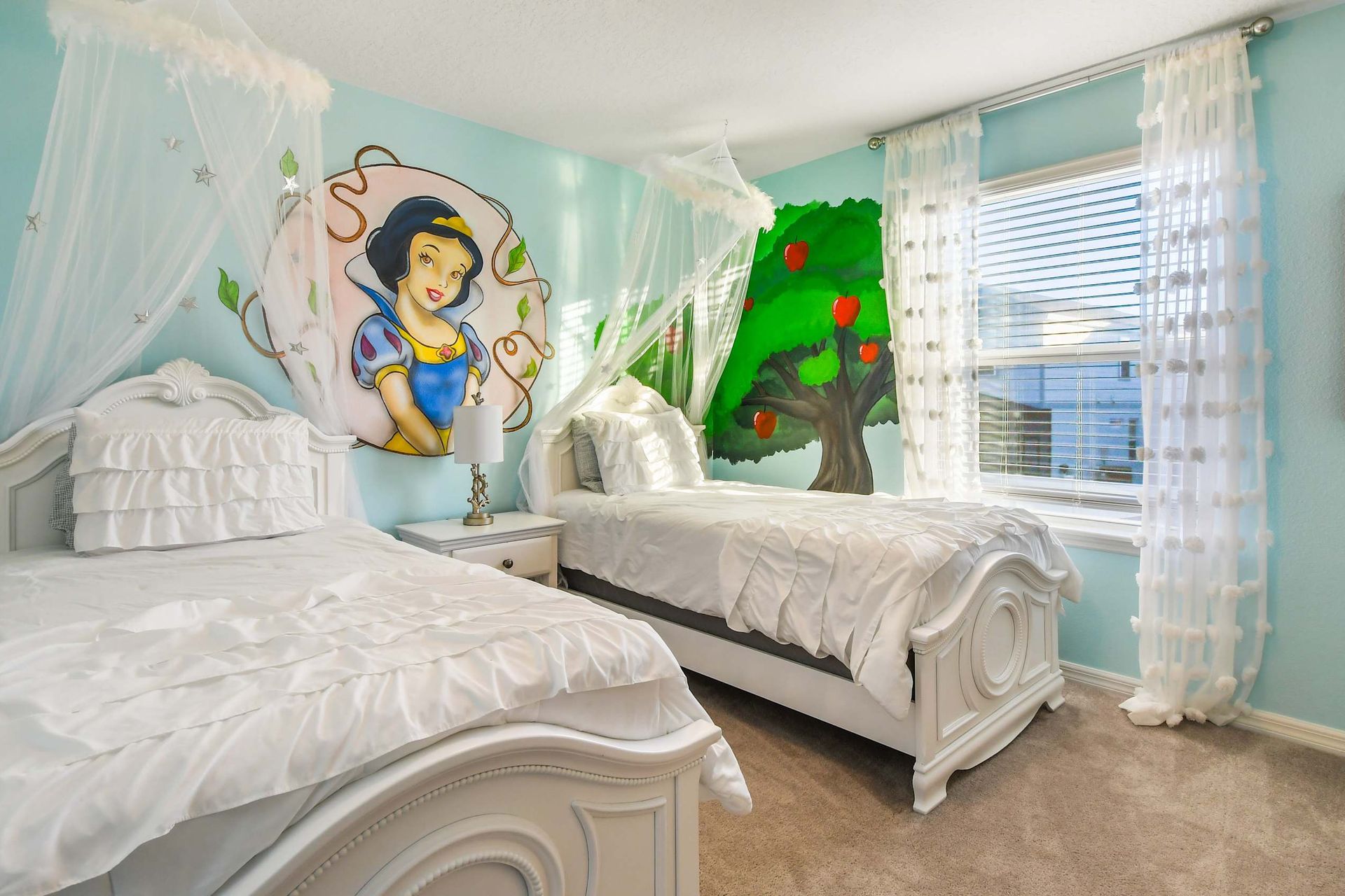 Enchanting princess-themed bedroom with twin beds, fairytale murals, and soft, whimsical decor.