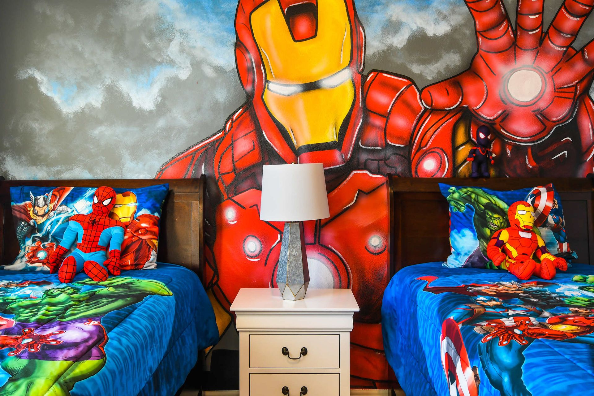 Superhero-themed kids' bedroom featuring vibrant wall art, twin beds, and fun Marvel decor accents!