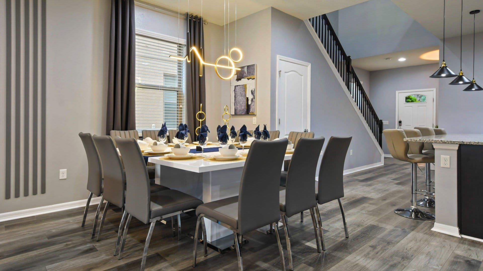 Stylish dining area with modern lighting, sleek decor & seating for the whole group!