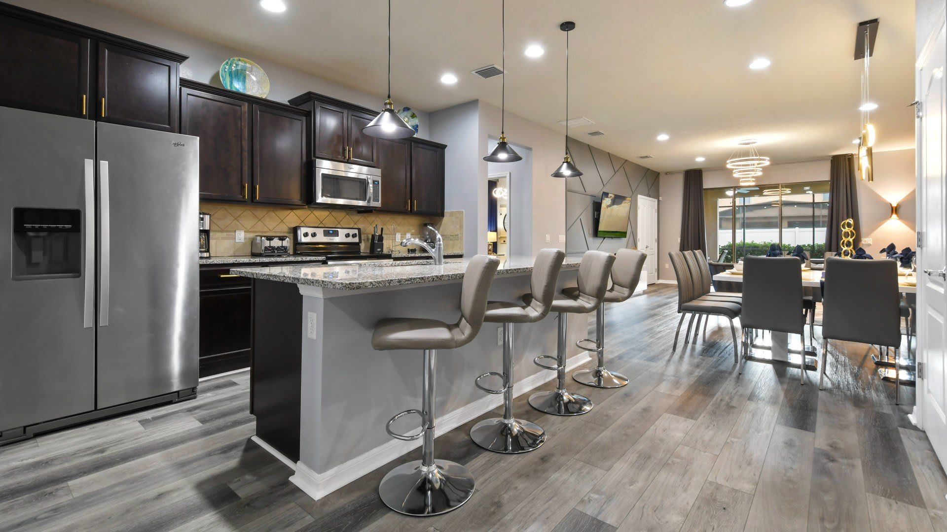 Modern kitchen & dining with sleek finishes, bar seating & open-concept design!