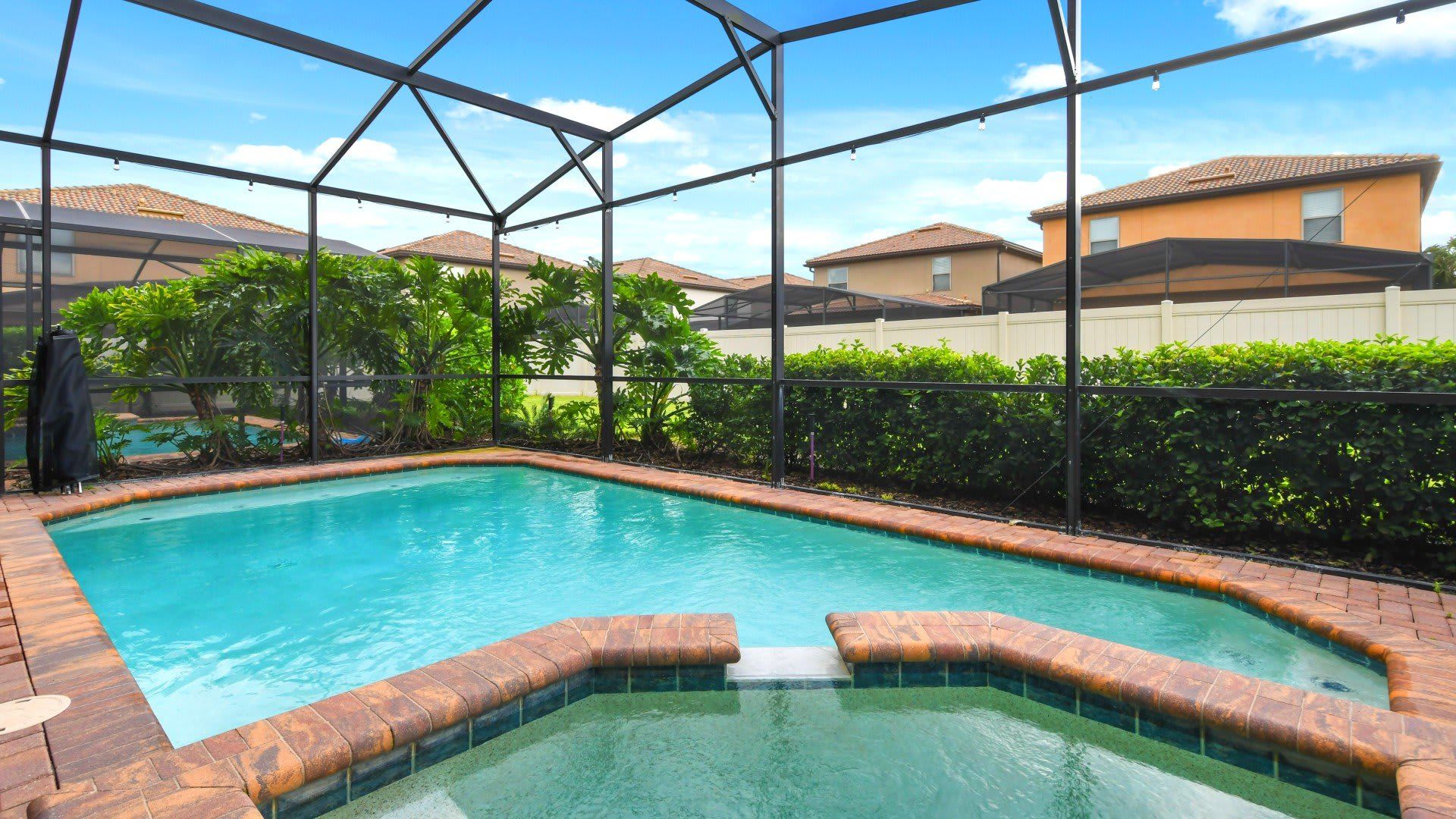 Private screened-in pool & spa with lush surroundings—your perfect getaway oasis!