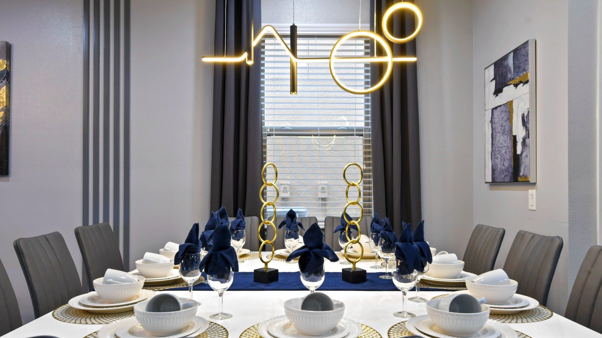 Elegant dining space with modern lighting, chic decor & a luxurious table setup!