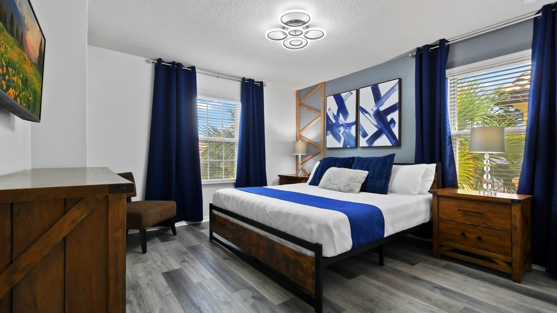 Stylish bedroom with modern decor, cozy bedding & natural light for a serene stay!