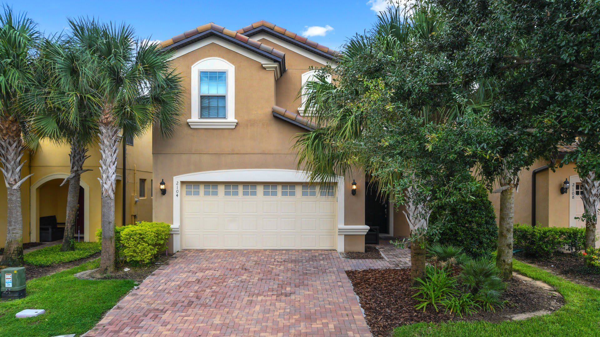 Stunning villa with lush landscaping, modern design & a warm, inviting entrance!