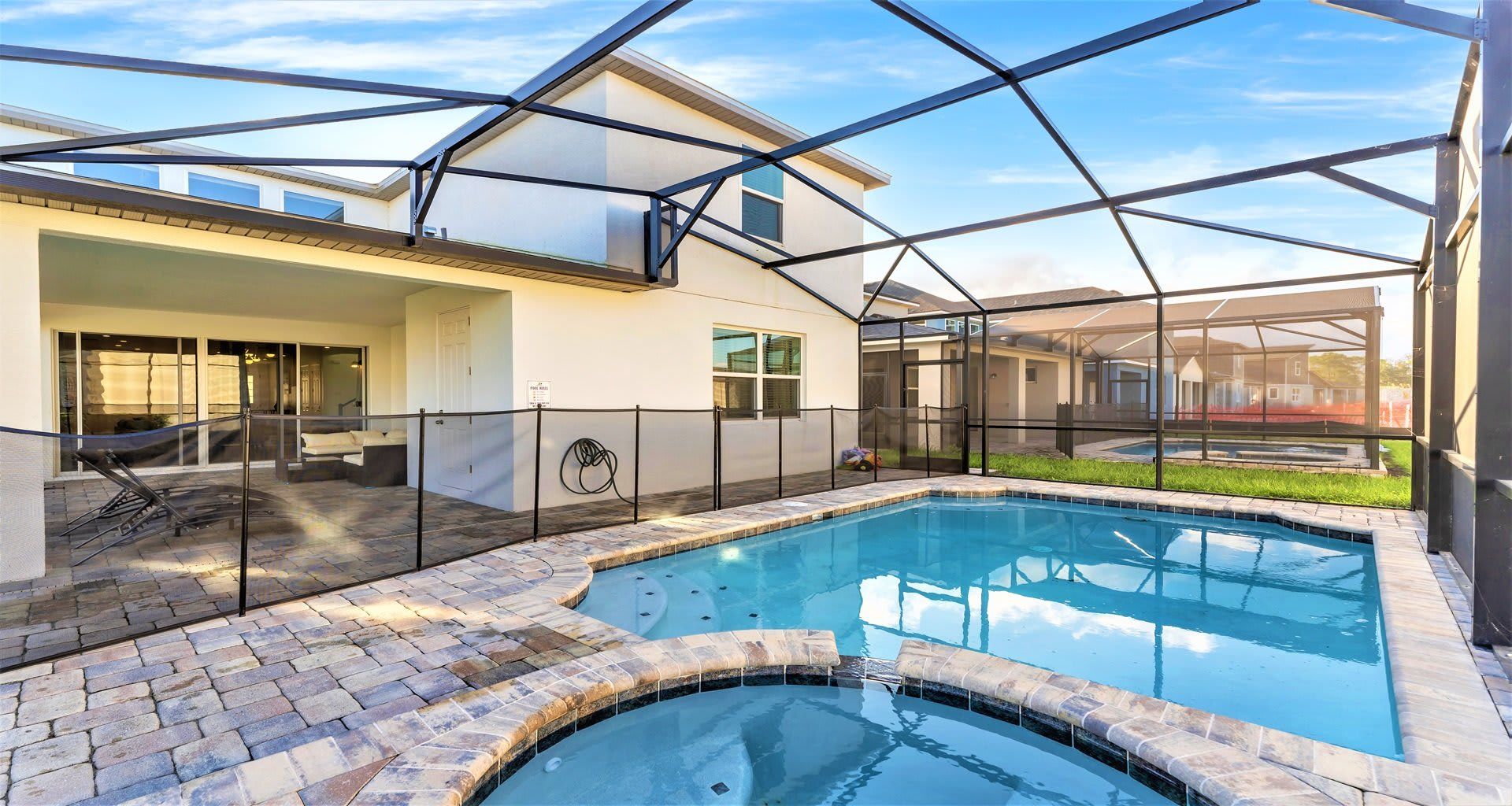 Luxury screened-in pool and spa with a spacious patio—perfect for relaxation!