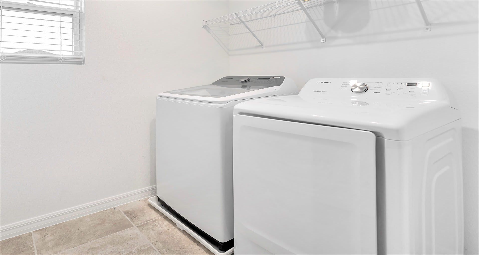 Convenient laundry room with modern washer and dryer for a hassle-free stay!