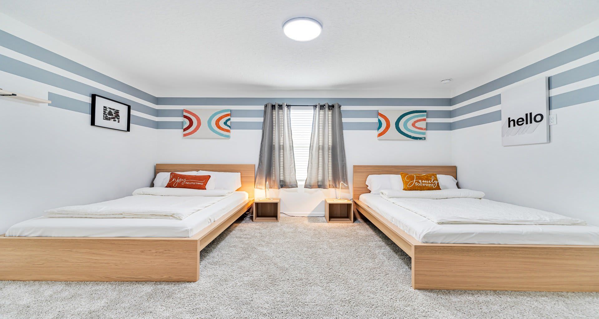 Modern and cozy twin bedroom with stylish décor, warm lighting, and a relaxing vibe!