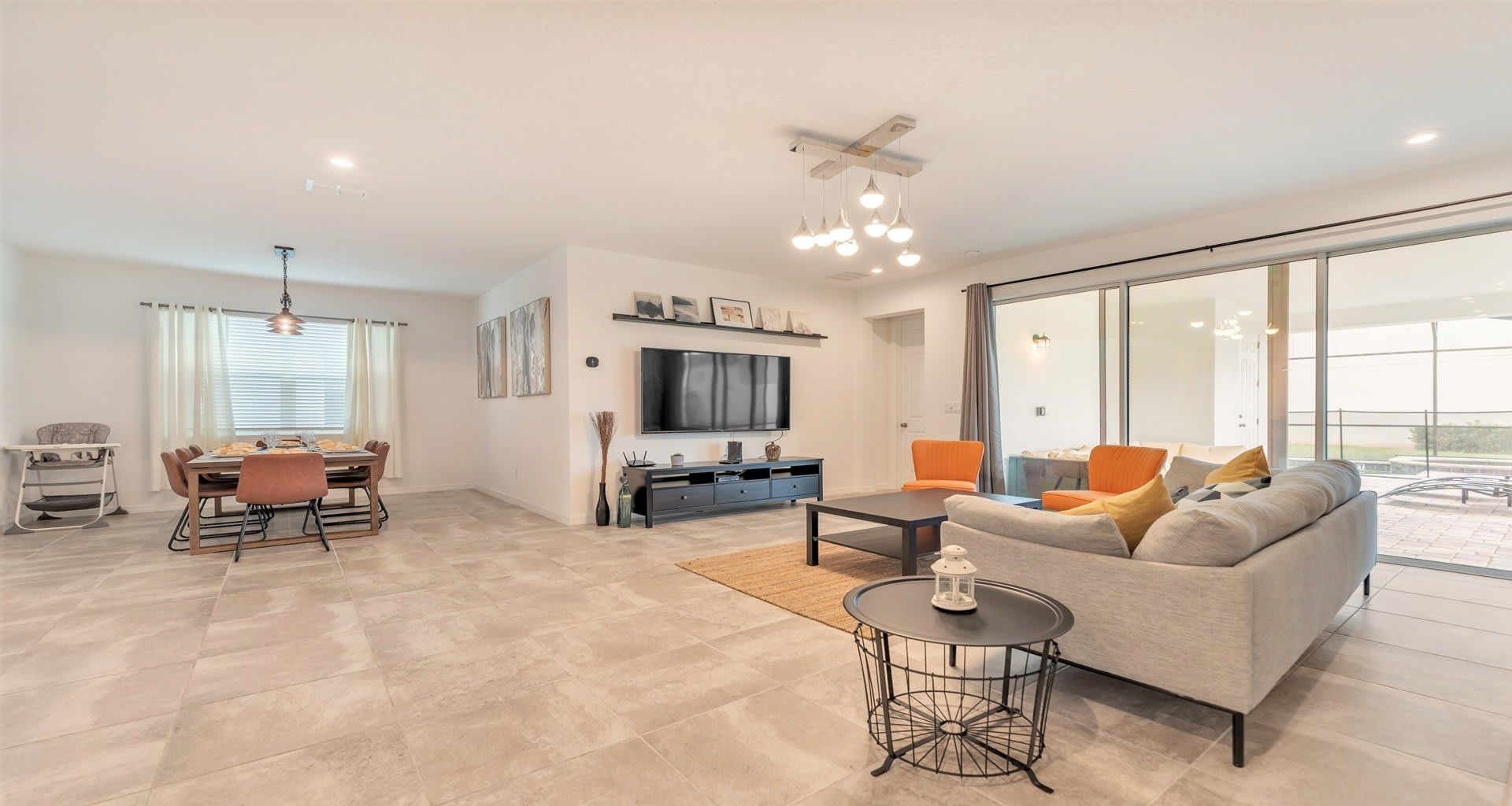 Spacious open-concept home with modern décor, dining area, and poolside access!