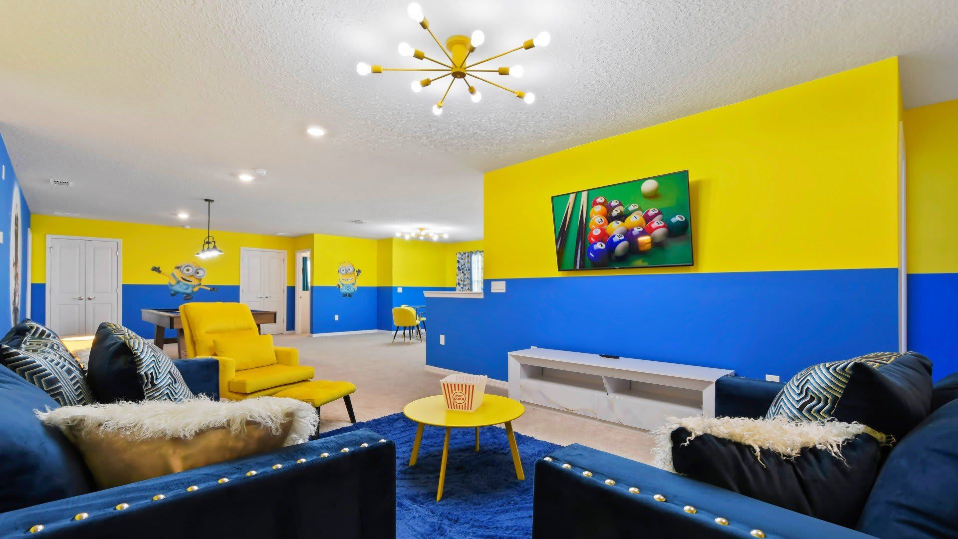 Fun, colorful family room with cozy seating, TV, and themed decor for all ages!