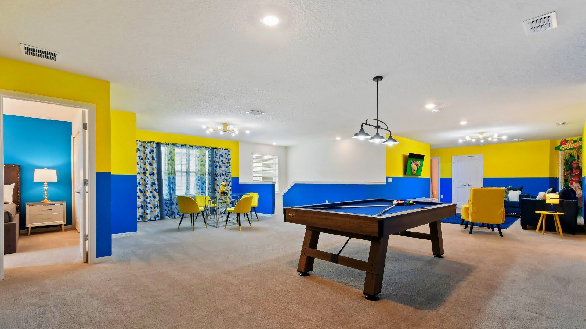 Spacious family room with pool table, vibrant decor, and cozy seating areas!