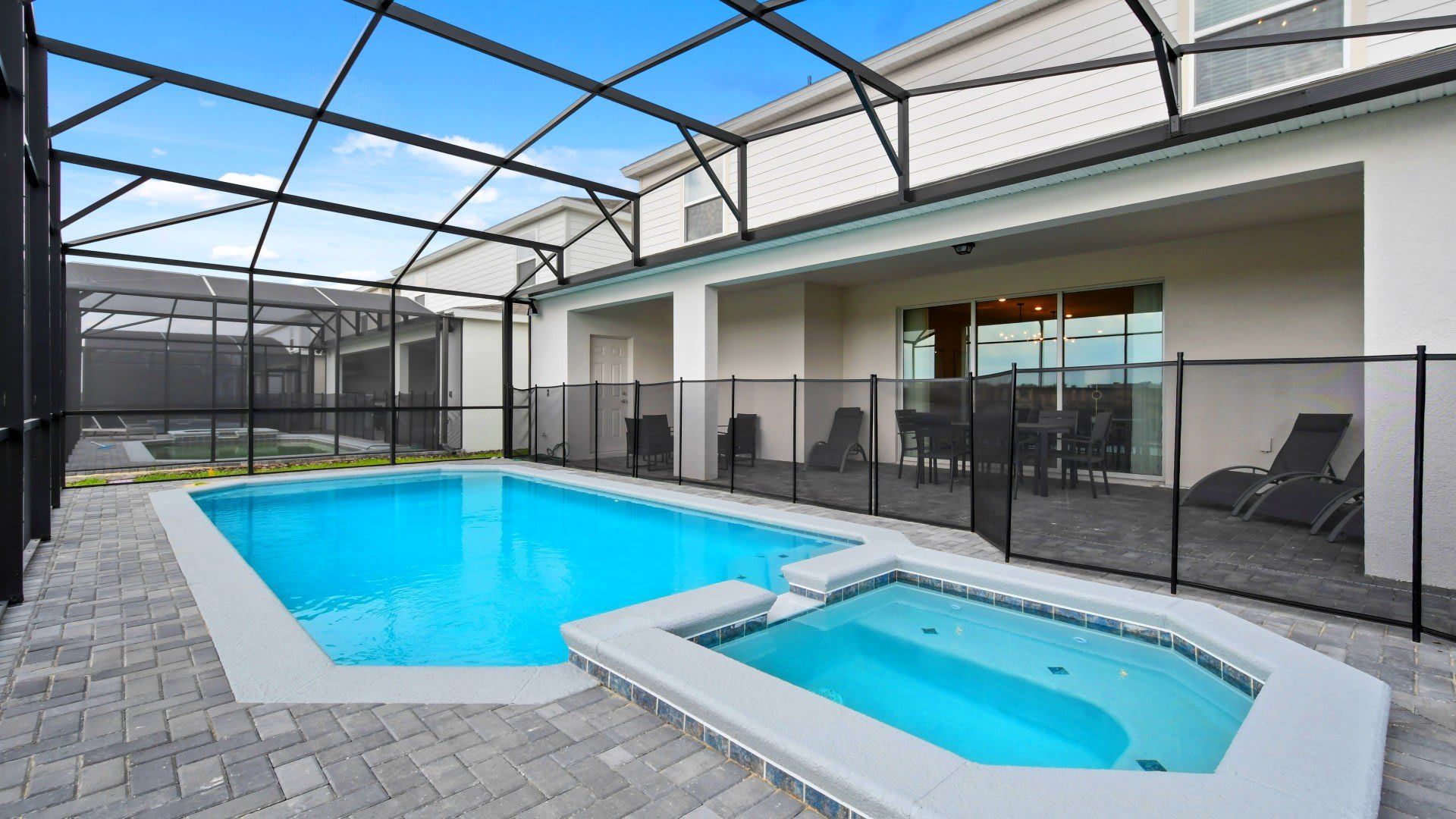 Private screened pool and spa with patio seating and lounge chairs for relaxation!