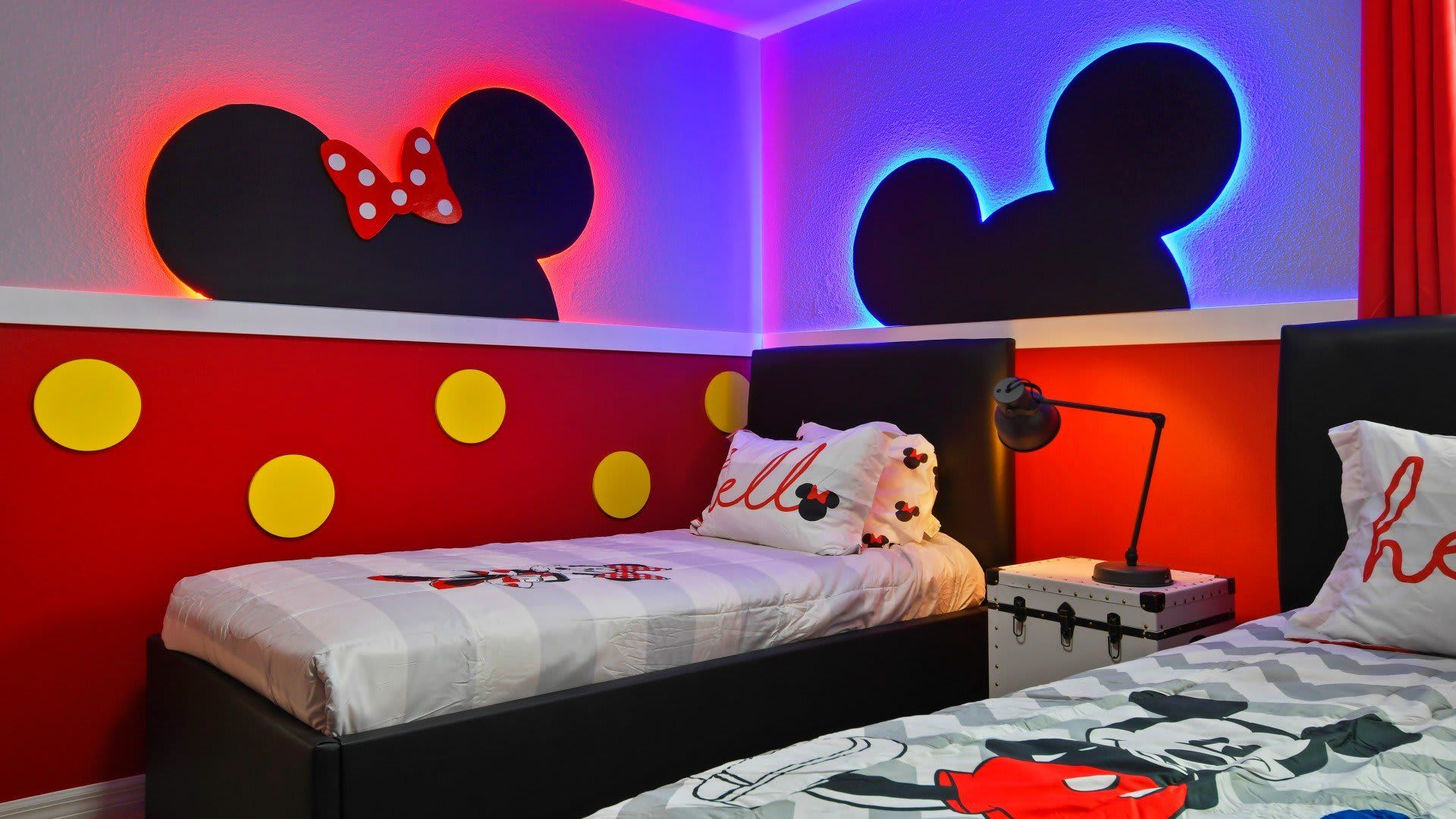 Whimsical Mickey-themed bedroom with vibrant decor and cozy twin beds for kids!