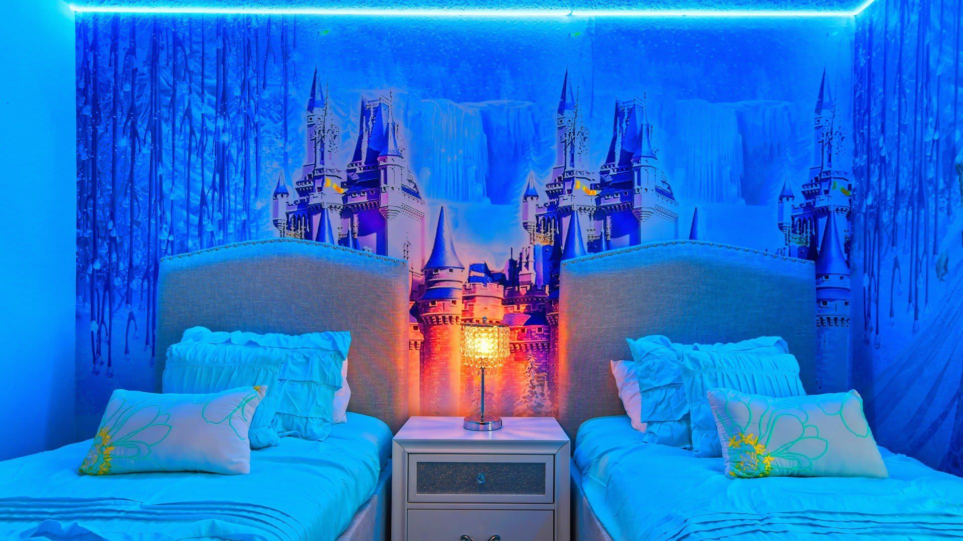 Magical Frozen-inspired bedroom with twin beds, castle mural, and glowing decor!