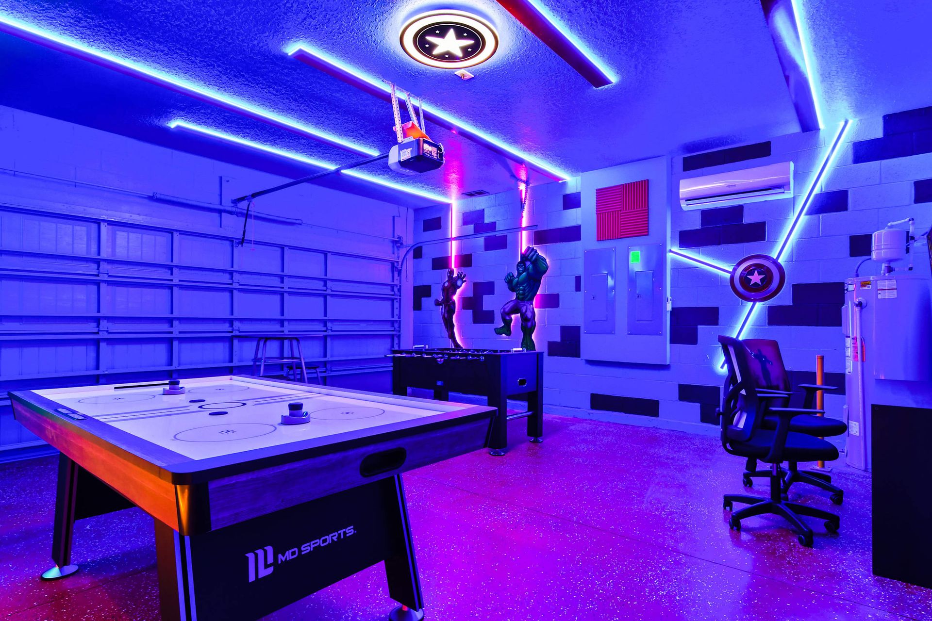 Immersive superhero-themed game room with air hockey, foosball, and neon lights!