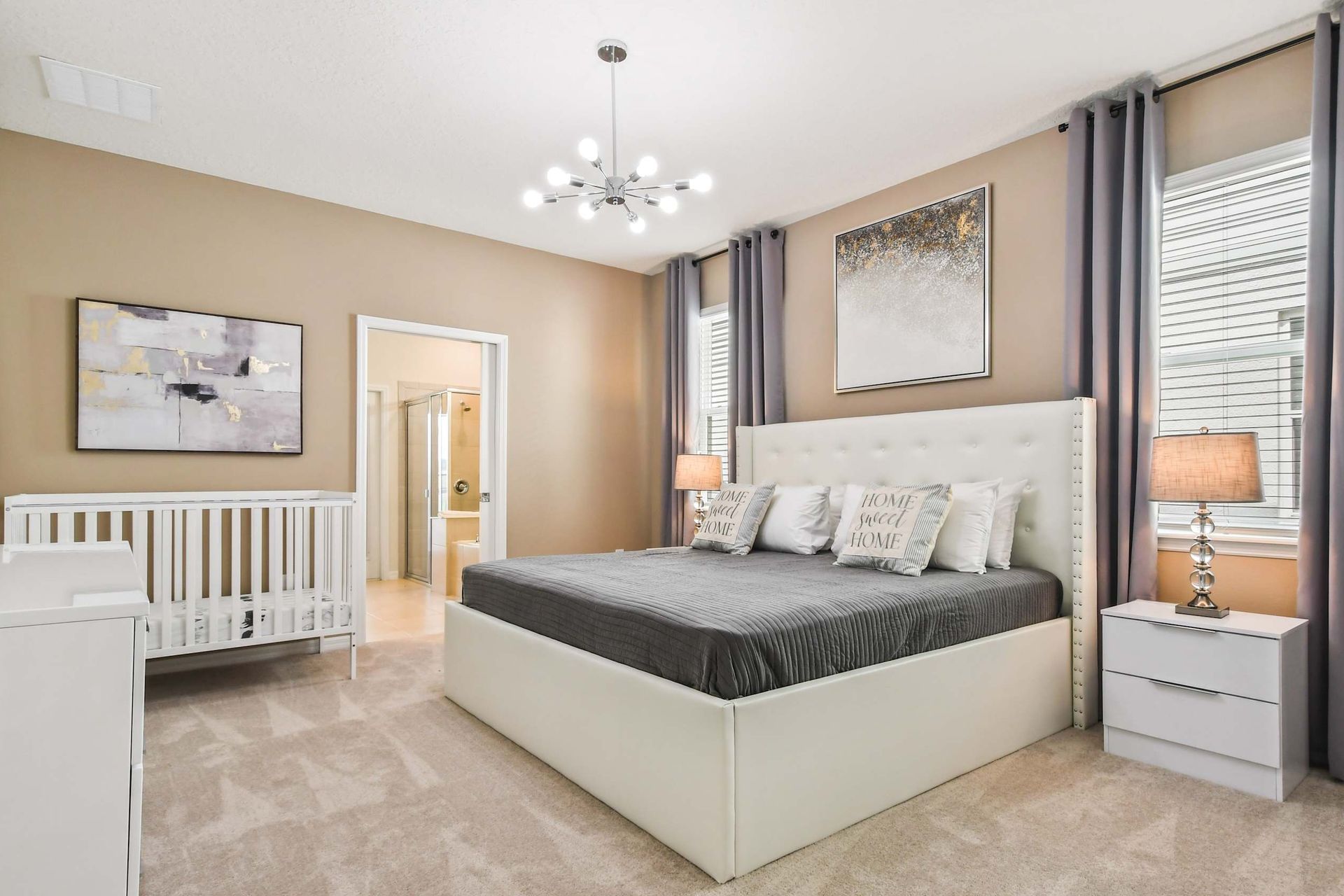 The master bedroom with a luxuriously large king bed & a crib