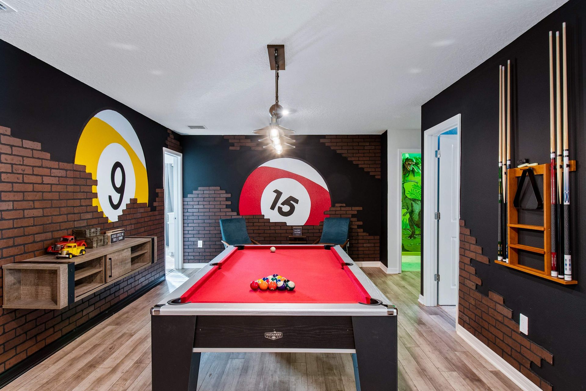 Stylish billiards room with bold murals, a red pool table & fun game vibes!