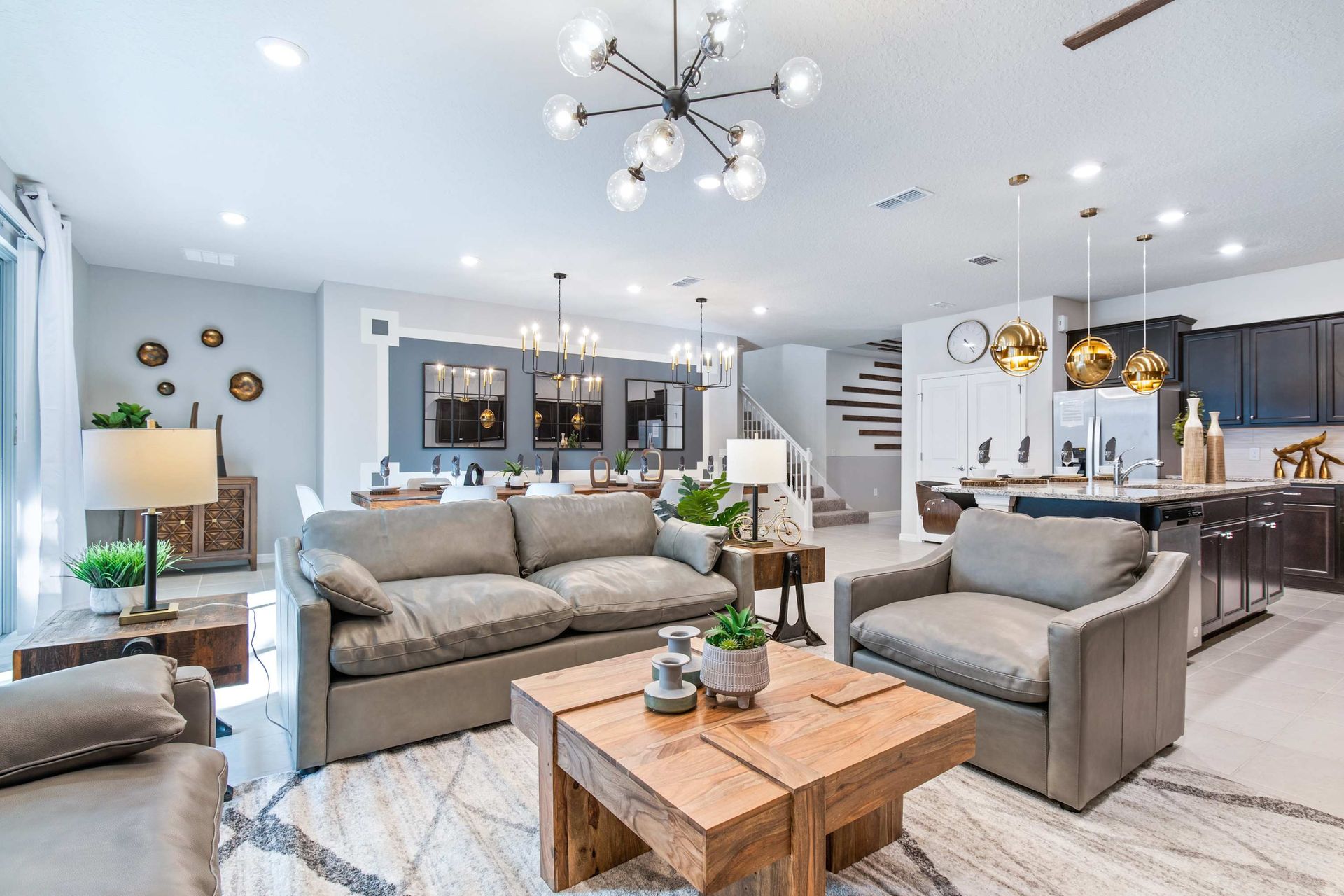 Relax and unwind in our modern and spacious living room. This area features comfortable seating, stylish decor and an open-plan layout that seamlessly connects to the dining and kitchen areas