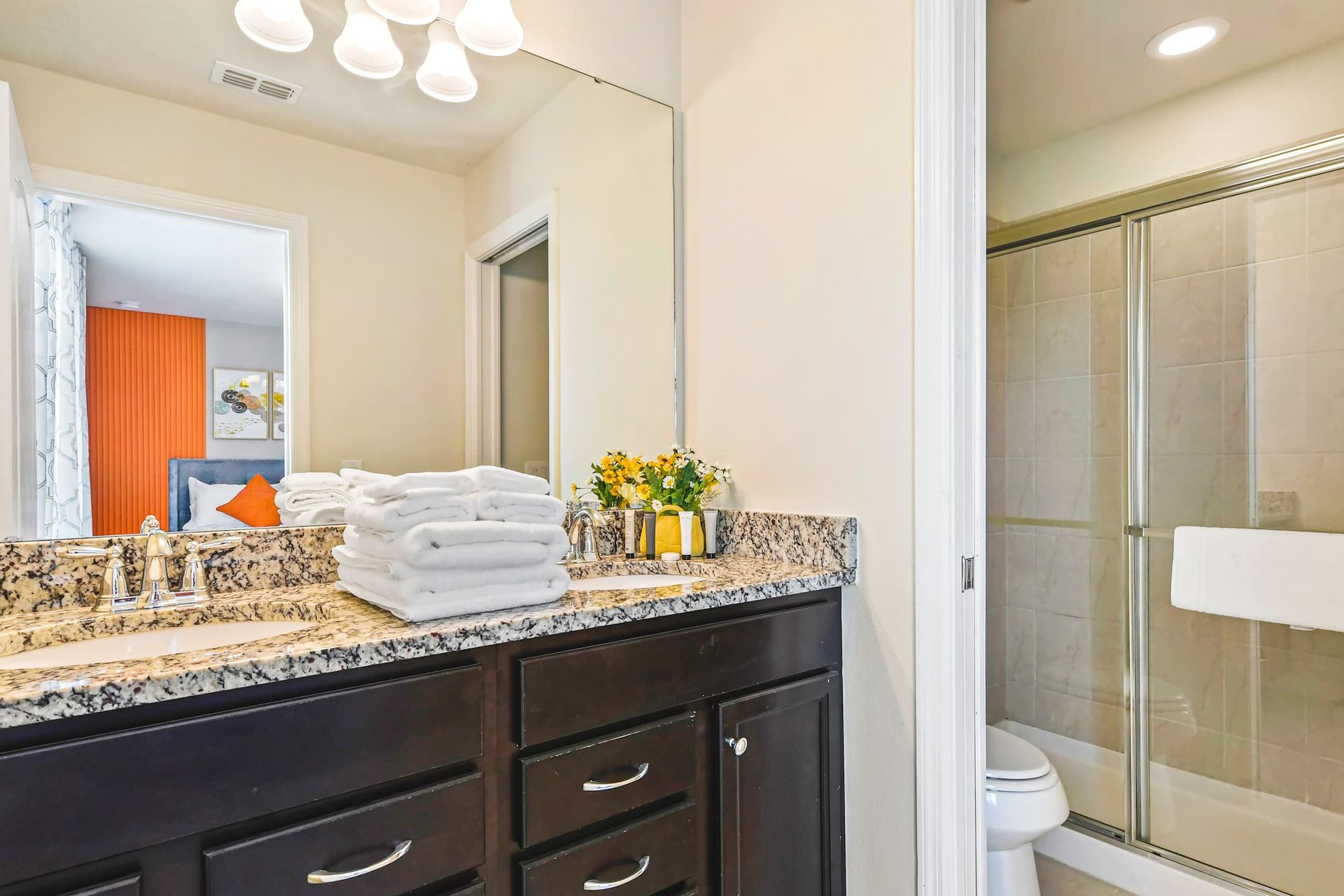 Modern bathroom with dual sinks, granite countertops & a sleek glass walk-in shower!