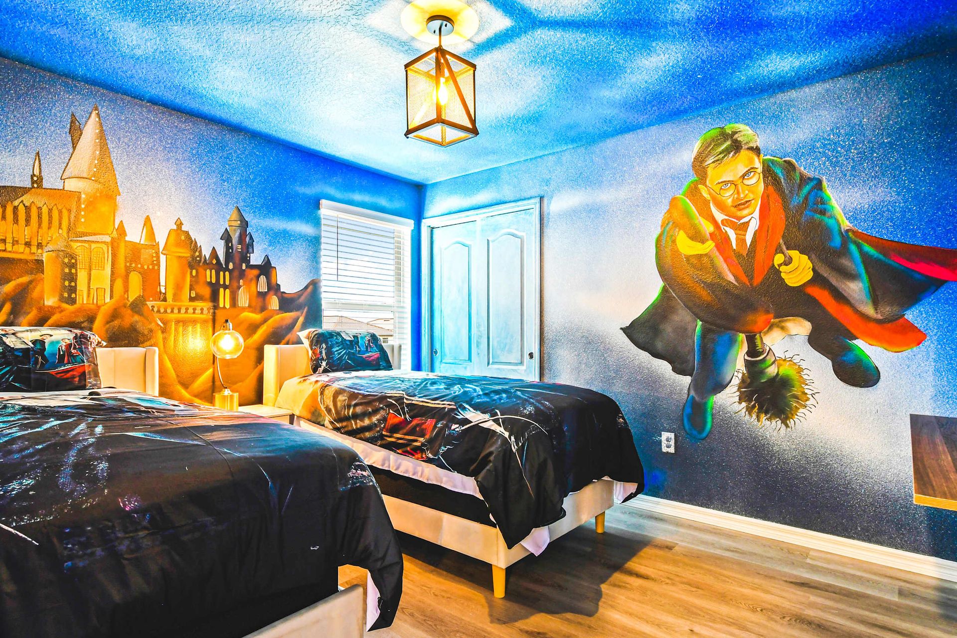 Step into a magical themed bedroom with twin beds and spellbinding wall art!