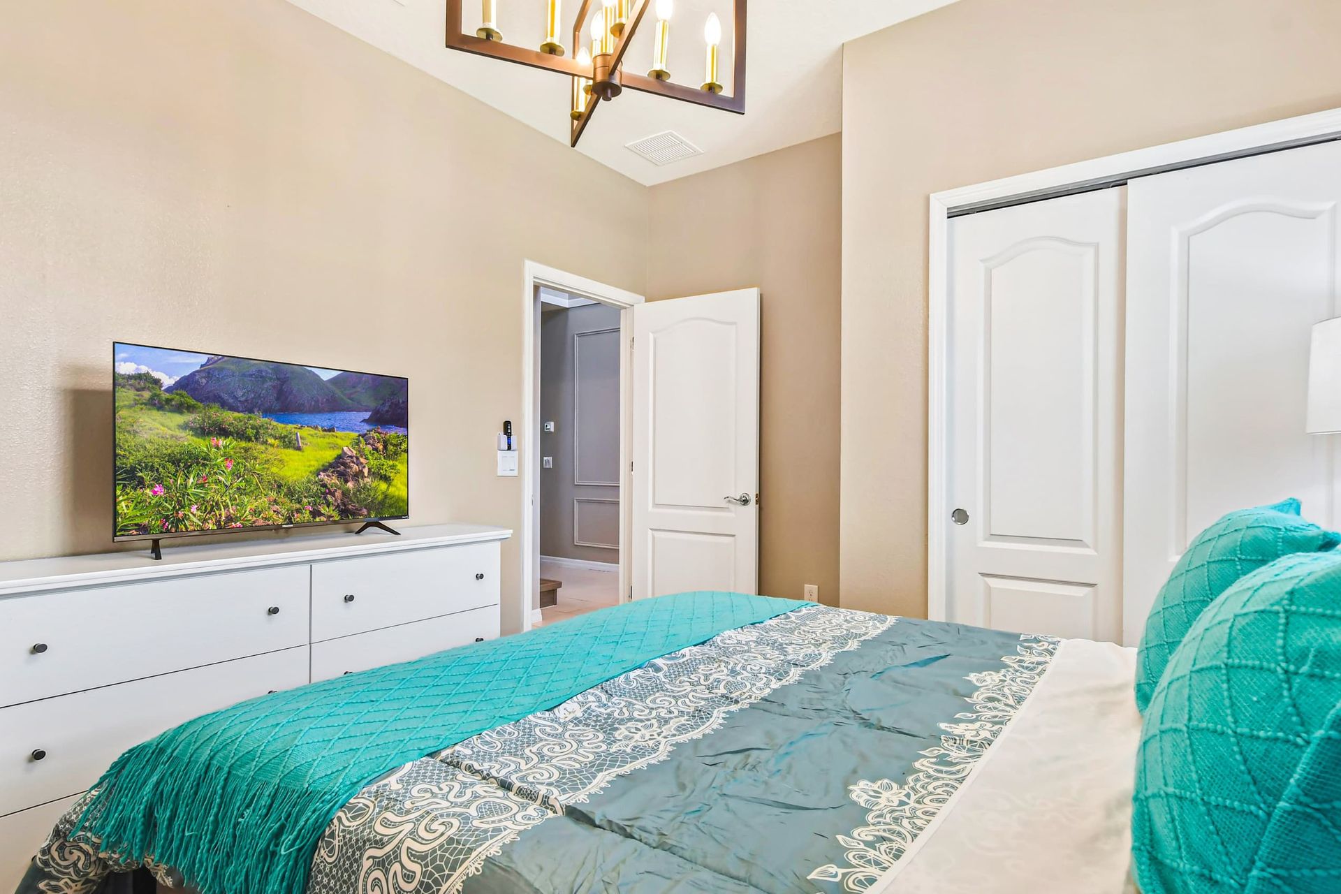 Stylish bedroom with modern decor, cozy bedding & natural light for a serene stay!