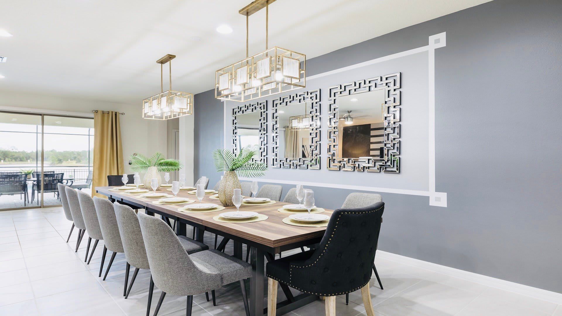 Elegant dining area with chic decor, modern lighting, and a beautiful view of the pool and lake.