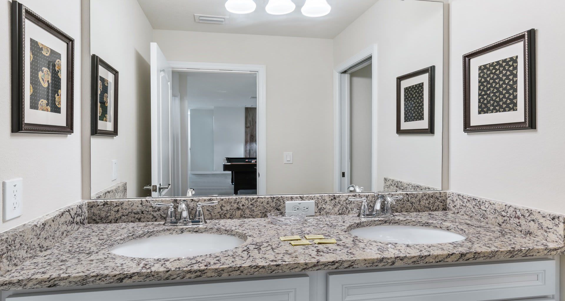Elegant bathroom with dual sinks, granite countertops, and a sleek, modern design!