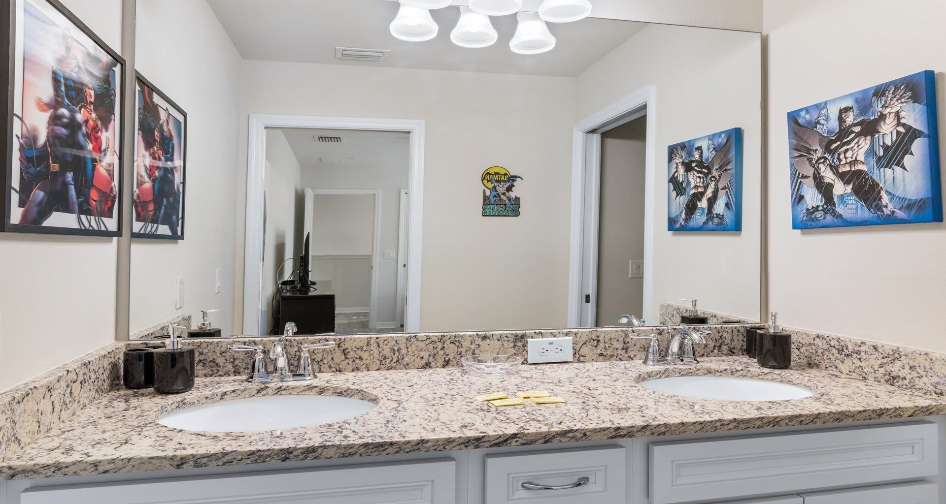 Hero-themed bathroom with dual sinks, granite countertops, and stylish comic decor!