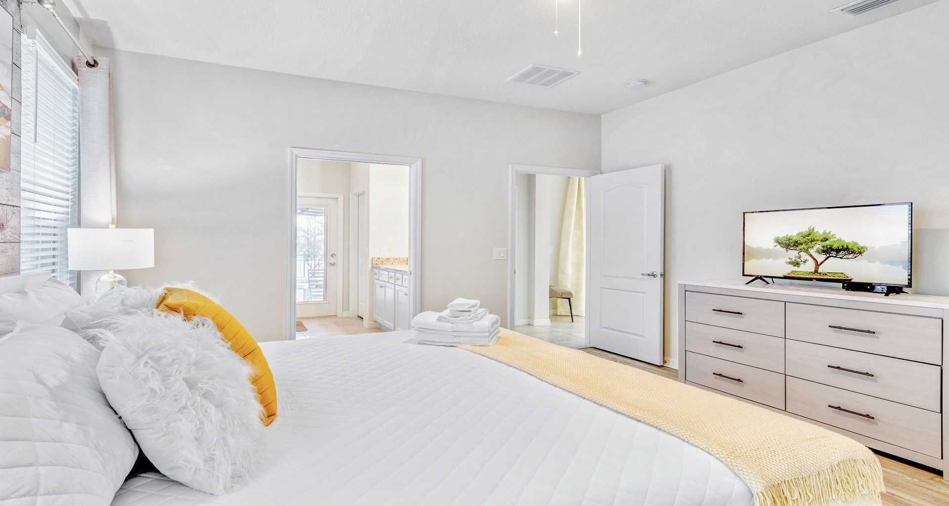 Spacious first floor bedroom with TV and connected bathroom.