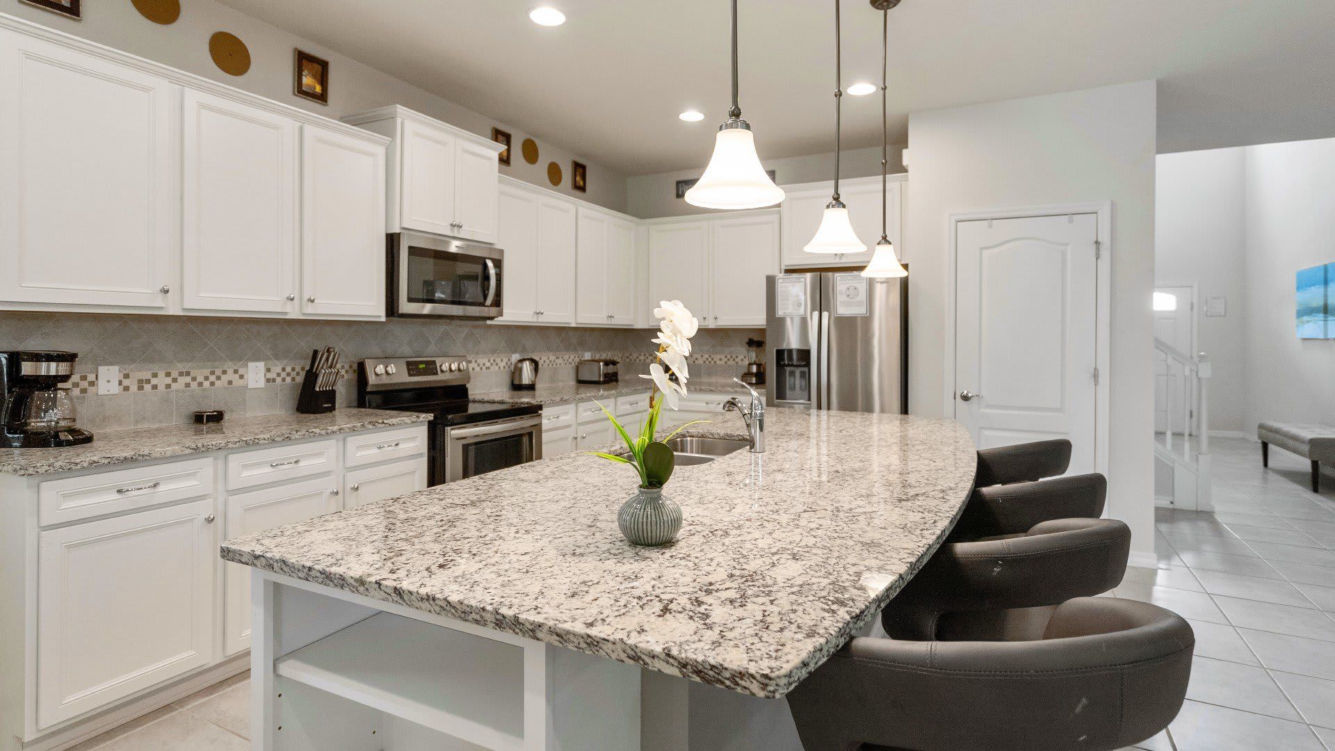 Spacious gourmet kitchen with granite countertops, sleek appliances, and bar seating!