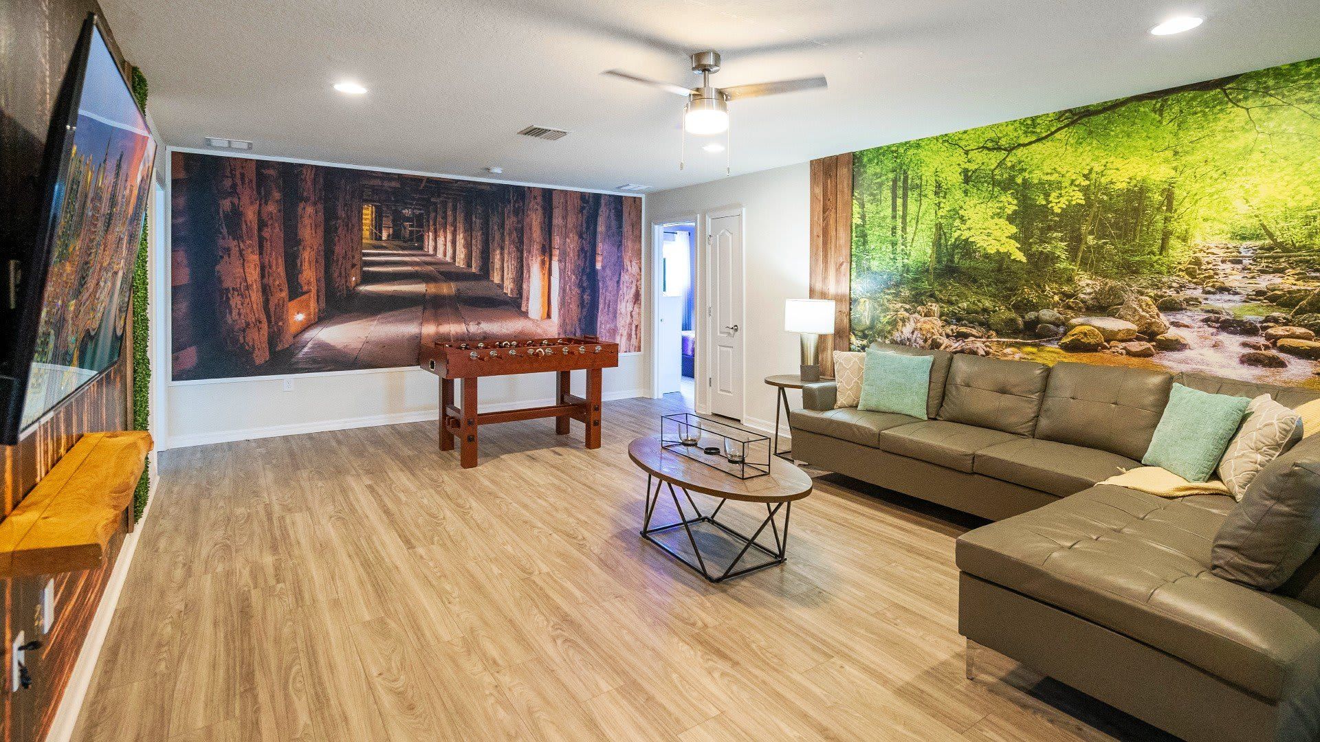 Unique nature-inspired game room with foosball, cozy seating, and immersive murals!