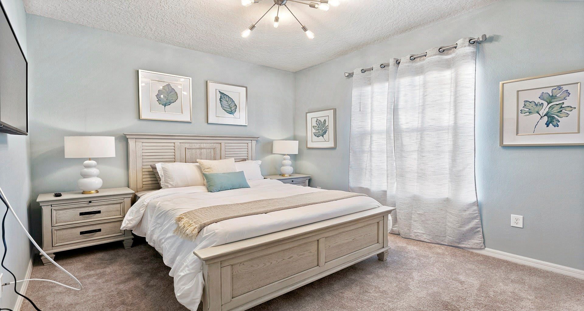 The master bedroom on the ground floor with a luxuriously large king bed