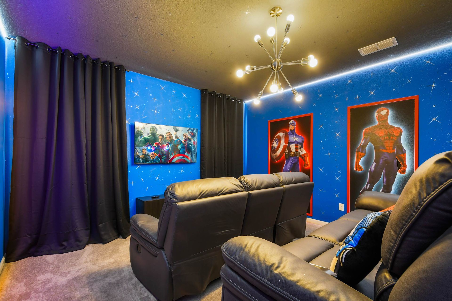 Enjoy movie nights in this Marvel-inspired home theater, complete with cozy recliners and posters of your favorite superheroes.
