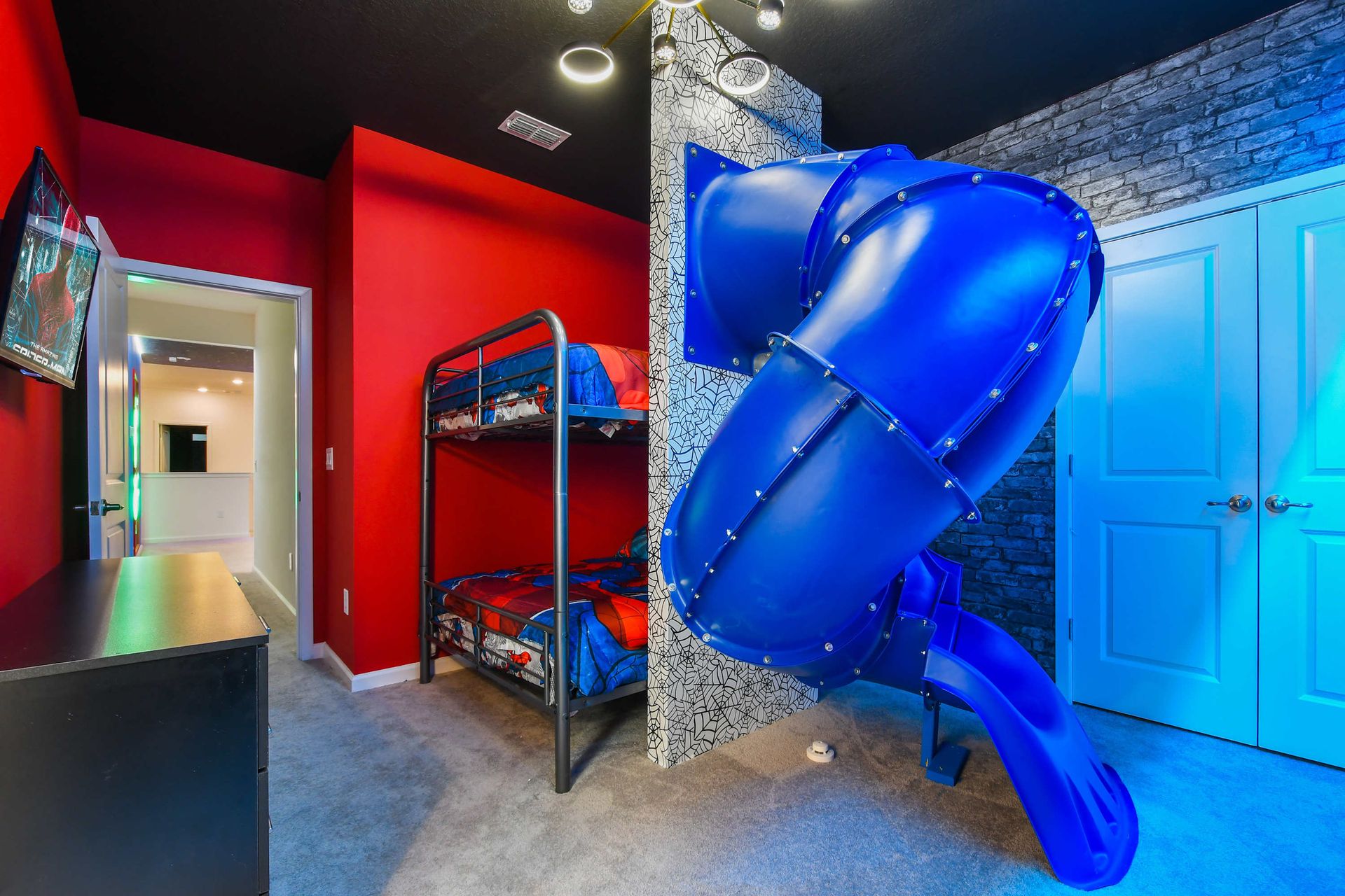 Slide into fun in this superhero-themed bunk room with bold colors and style.
