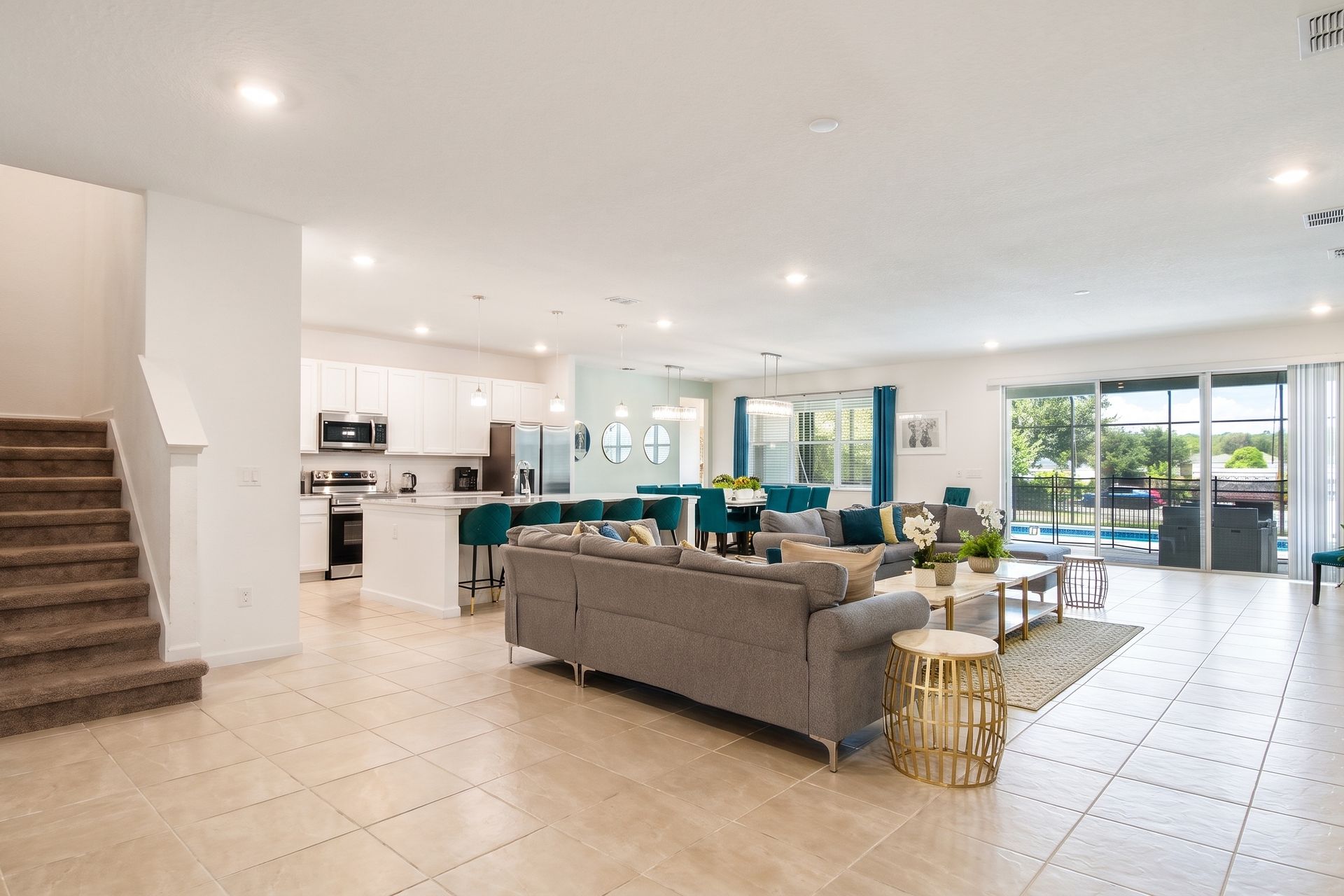 Open-concept living space with modern décor, natural light, and a private pool view!