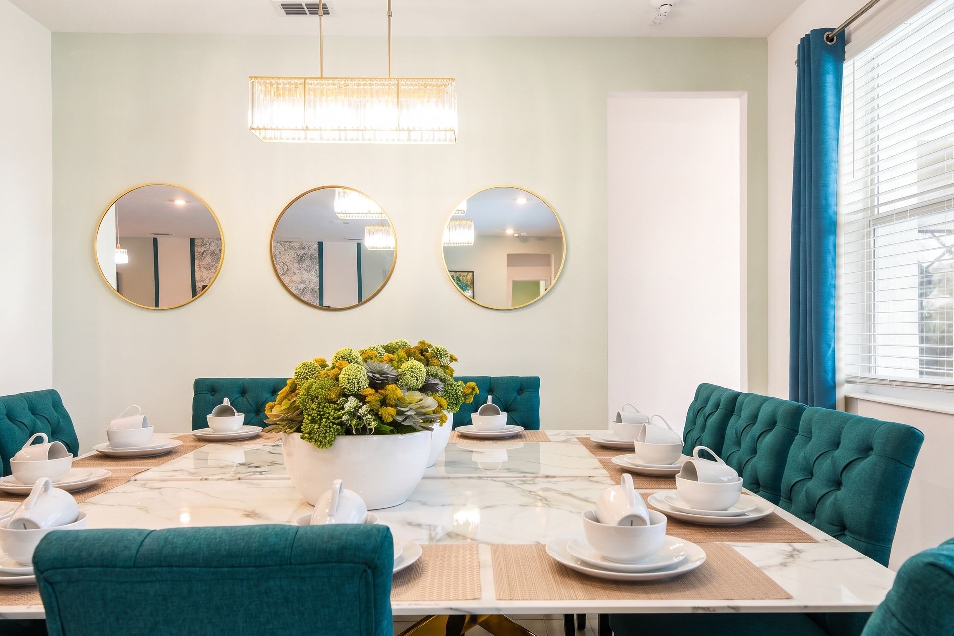 Sophisticated dining space with a marble table, plush seating, and elegant lighting!