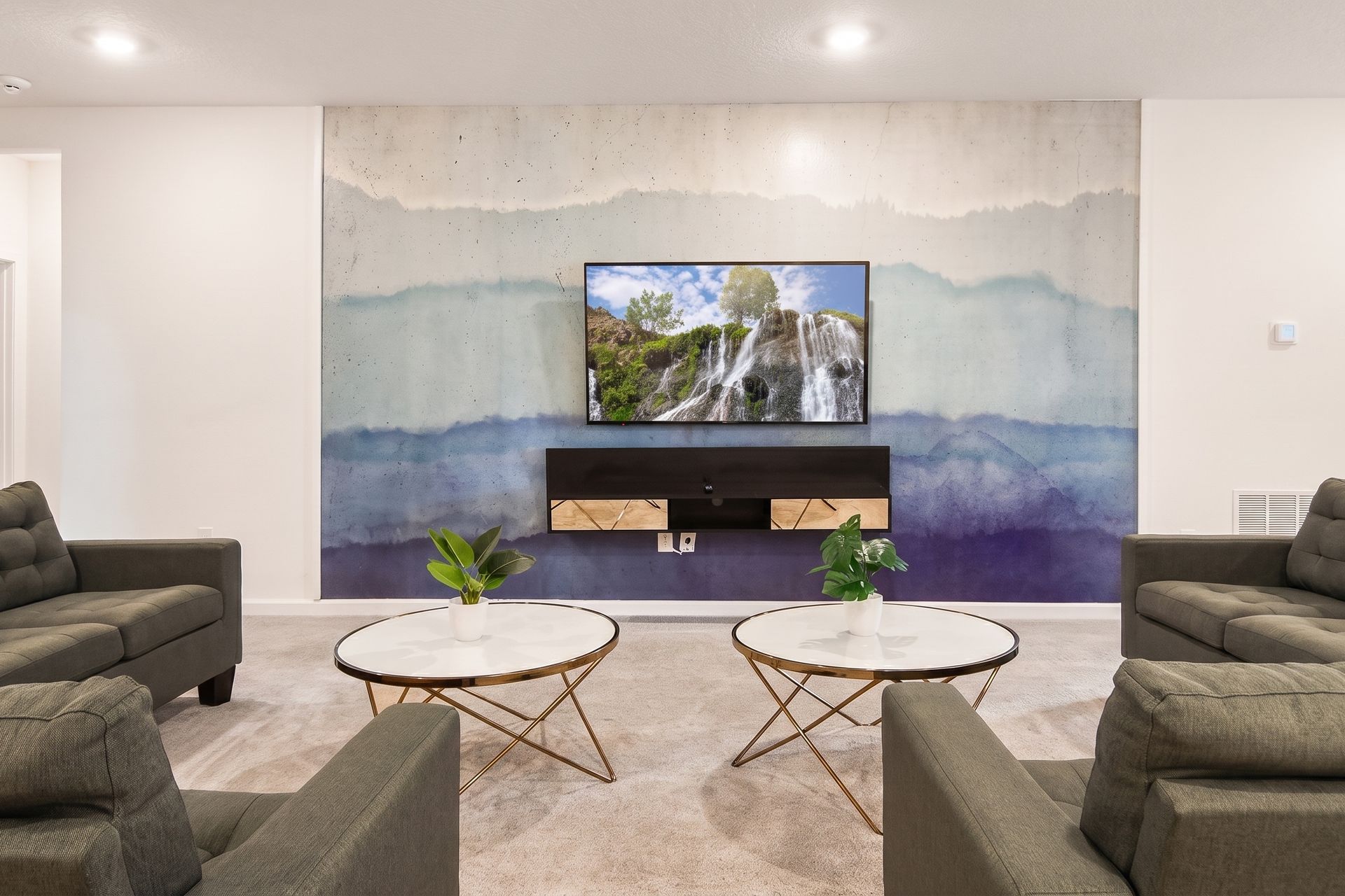 Stylish lounge with modern décor, cozy seating, and a stunning accent wall!