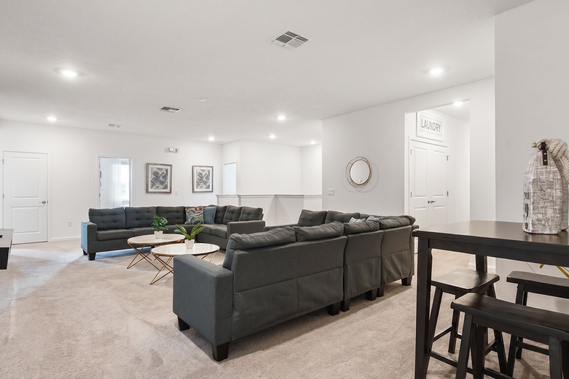 Spacious upstairs lounge with plush seating, cozy vibes, and a stylish entertainment area!