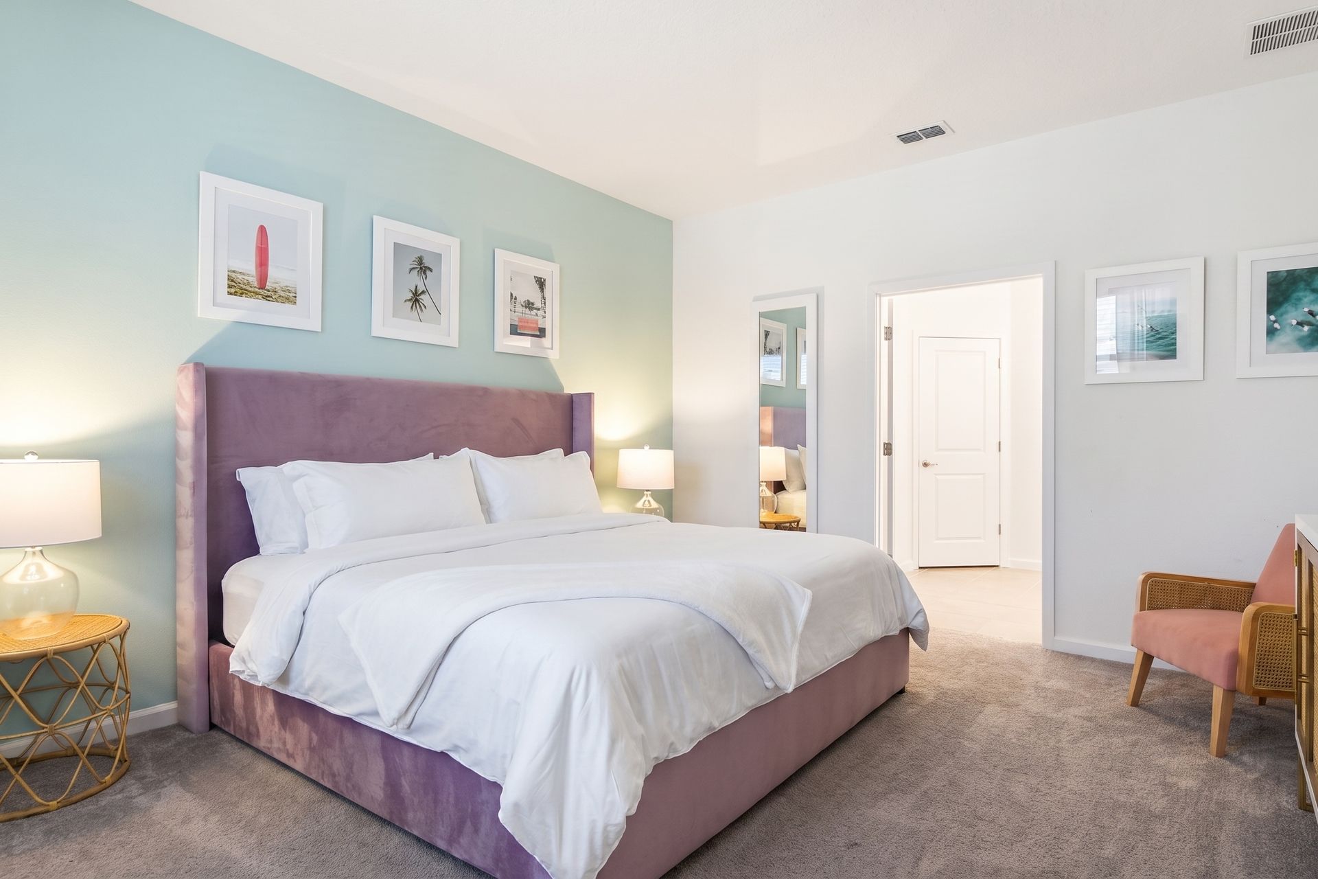 Chic tropical-themed bedroom with a plush bed, soft pastels, and relaxing vibes!