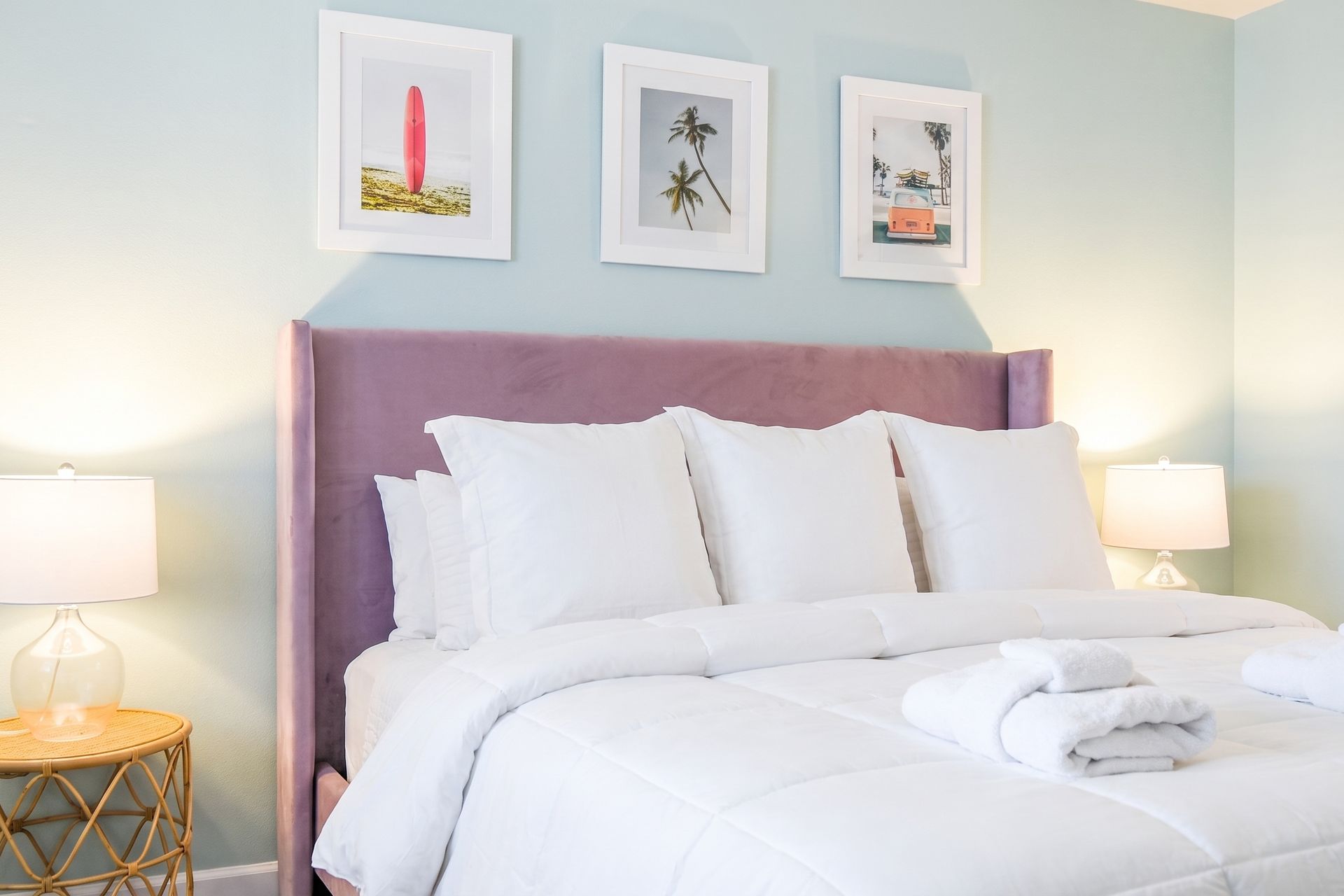 Bright and cheerful bedroom with a plush bed, hanging chair, and sunny décor!