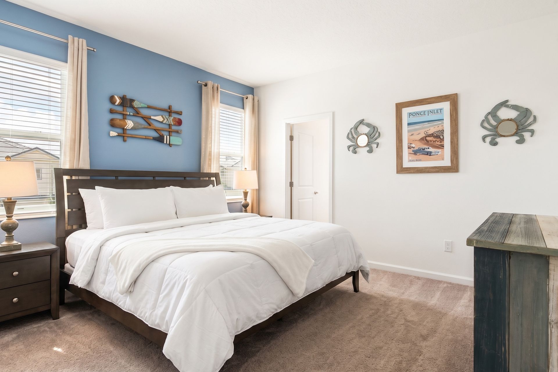 Coastal-inspired bedroom with rustic décor, a comfy bed, and relaxing beachy vibes!