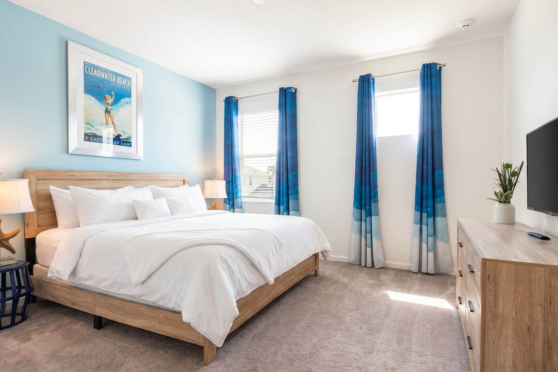Coastal-inspired bedroom with serene blue tones, a cozy bed, and beachy décor!