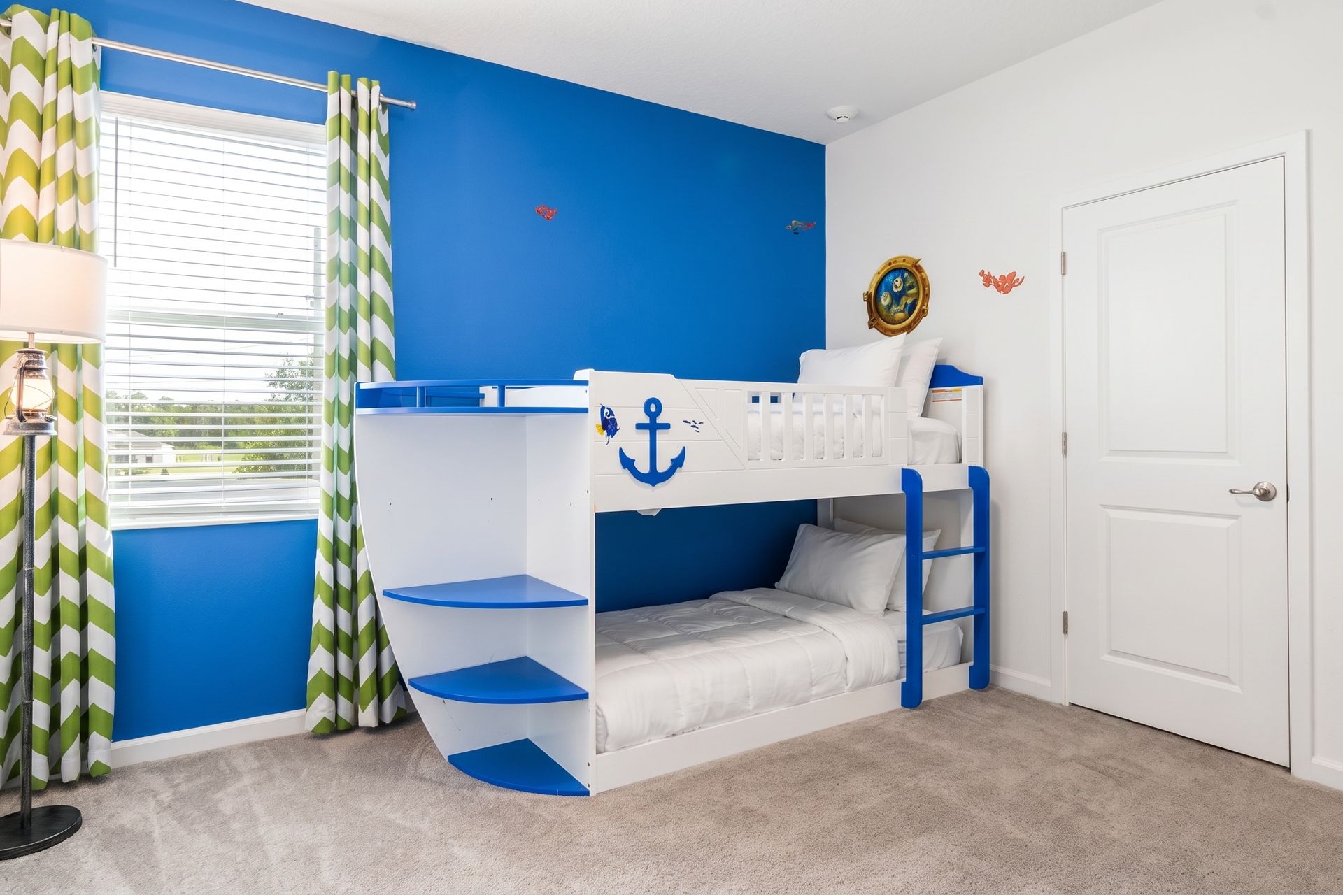 Nautical-themed kids' room with a fun boat bunk bed—perfect for little adventurers! 