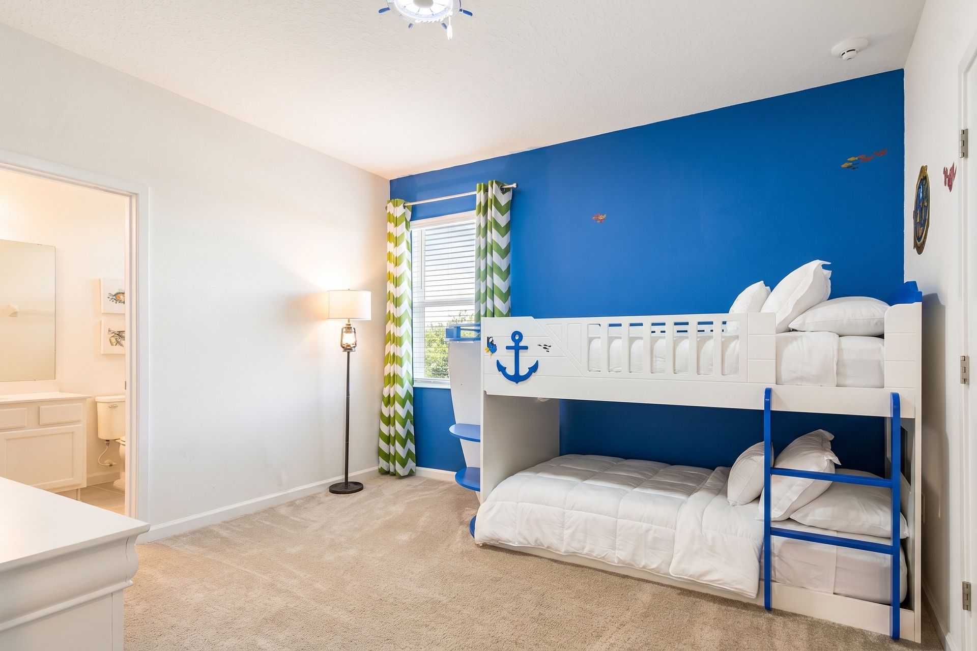 Bright nautical-themed room with a fun boat bunk bed—perfect for little sailors!