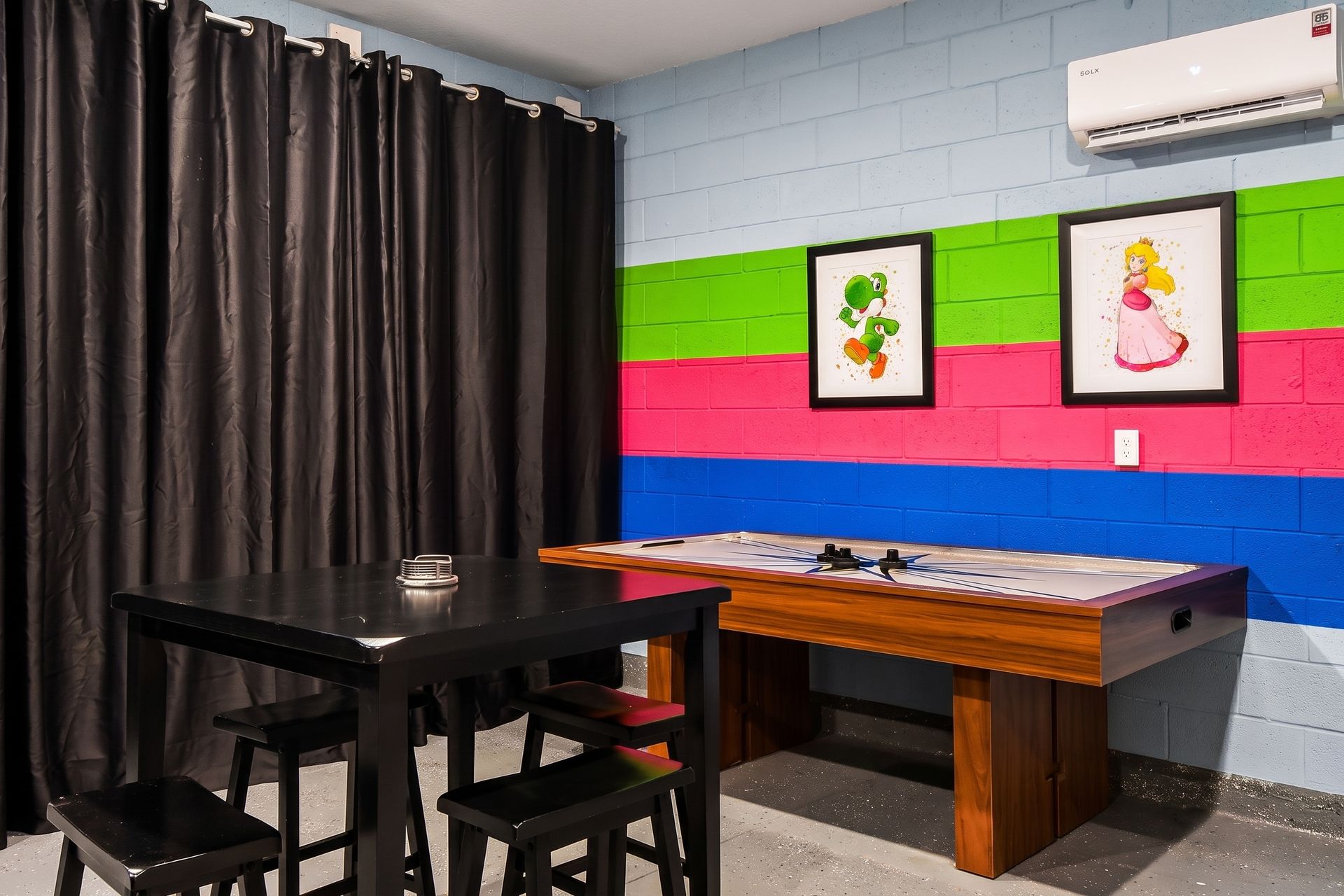 Colorful game room with air hockey, fun décor, and a cozy hangout space!