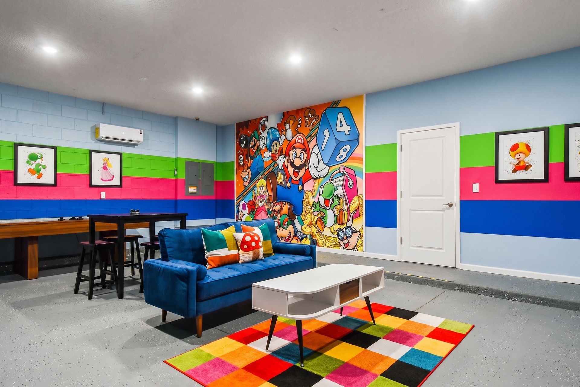 A fun and vibrant game room with arcade decor, seating areas, and game tables - providing entertainment for guest of all ages.